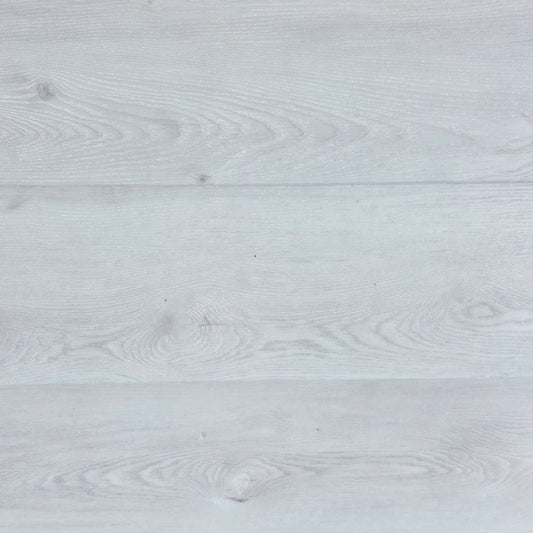 Close-up of a light white hybrid flooring with grey visible grain.