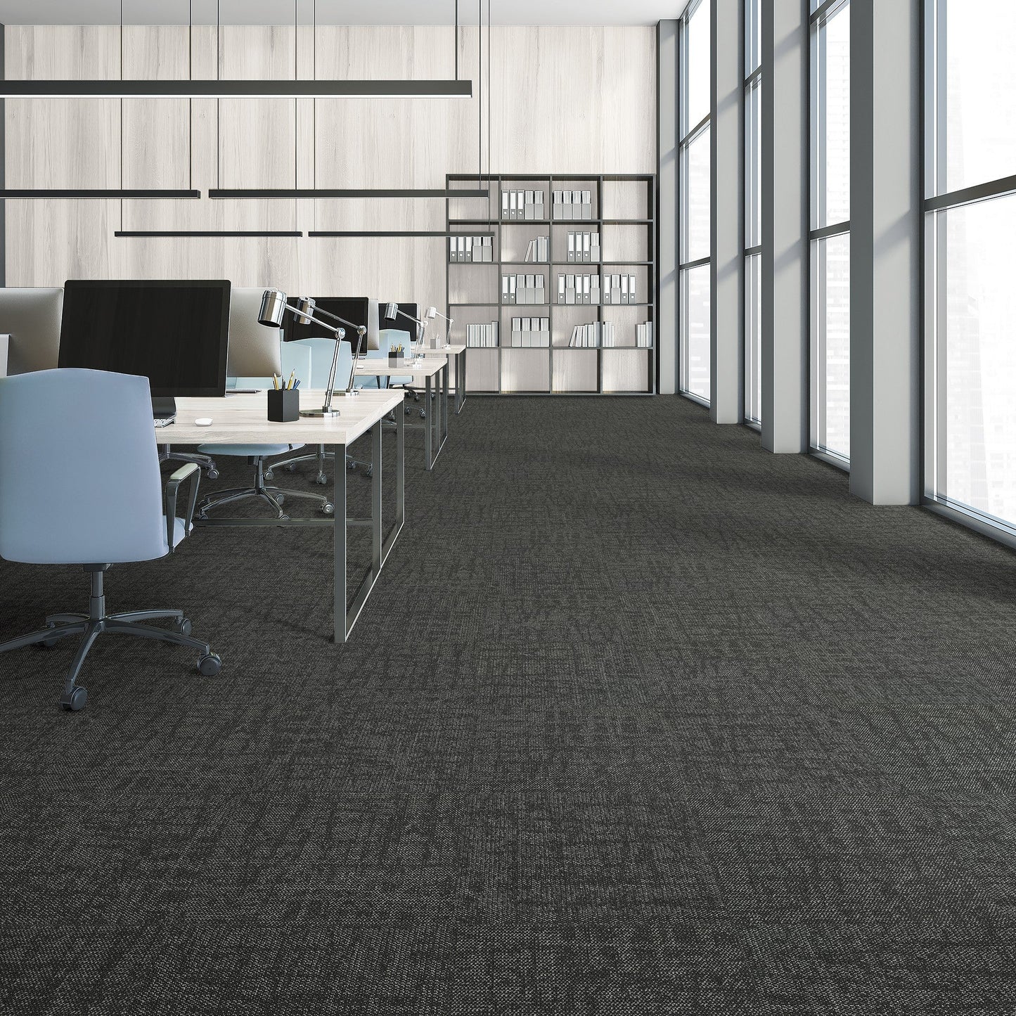 Modern office space with desks, chairs, and large windows.