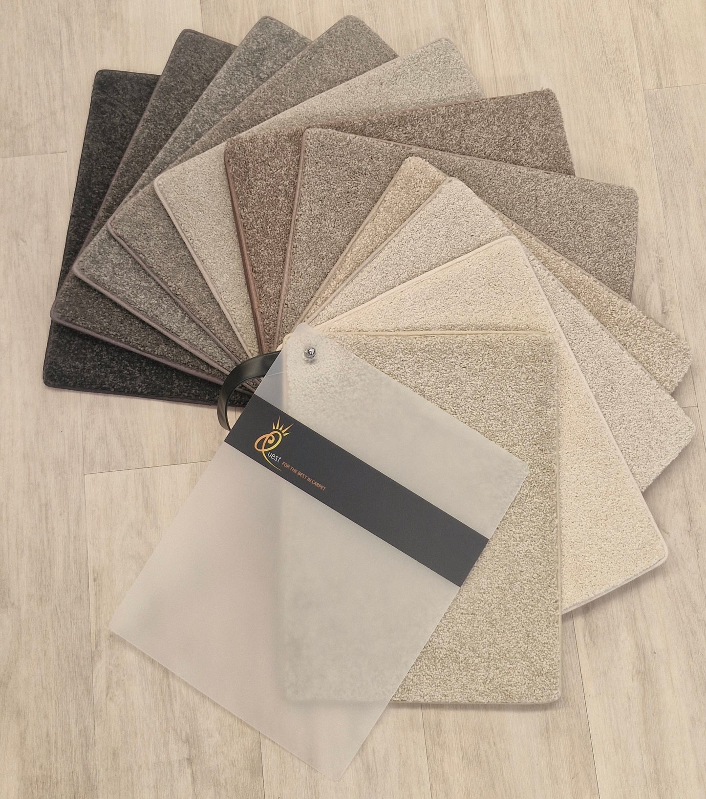Collection of carpet samples in various shades.