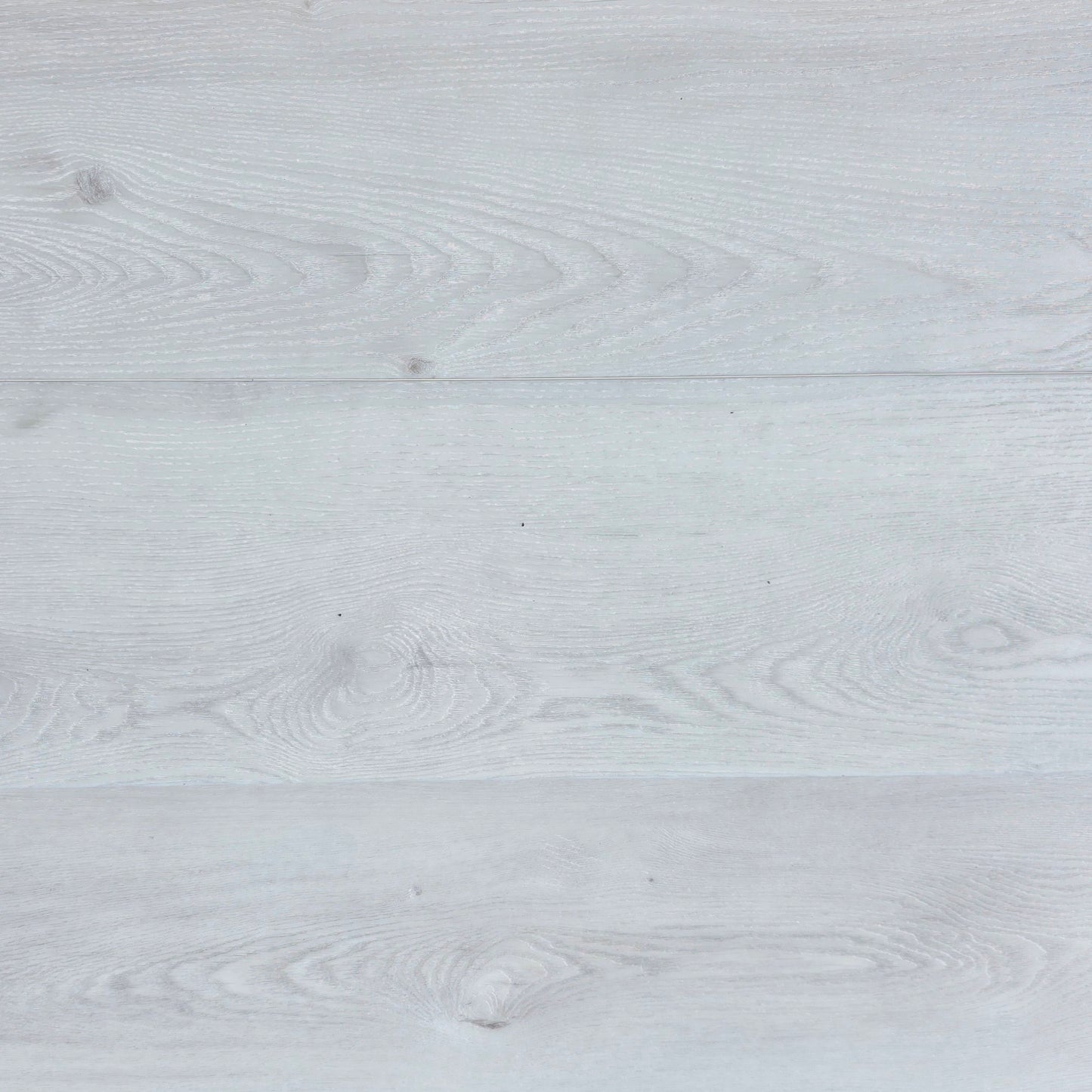 Close-up of a light white hybrid flooring with grey visible grain.
