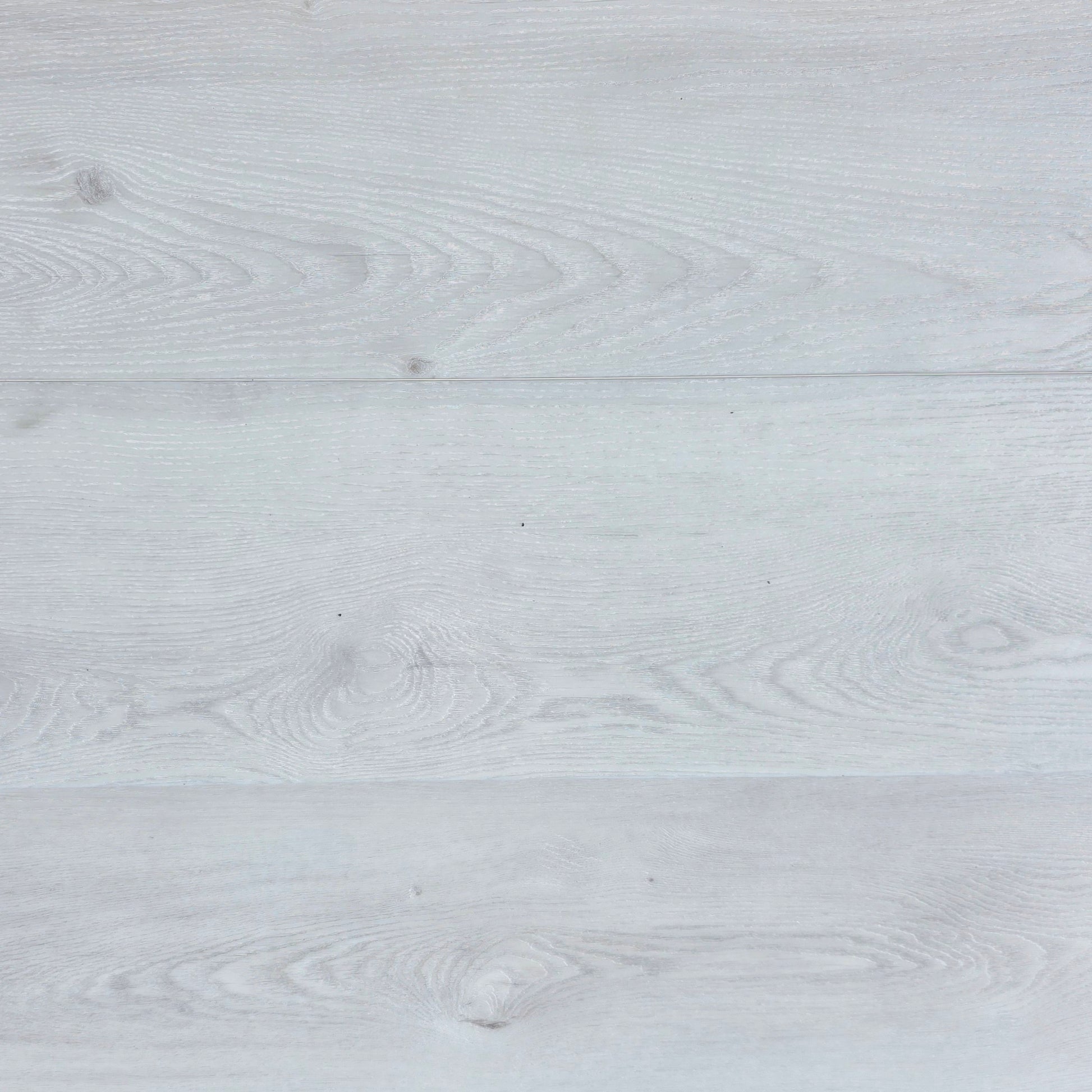 Close-up of a light white hybrid flooring with grey visible grain.