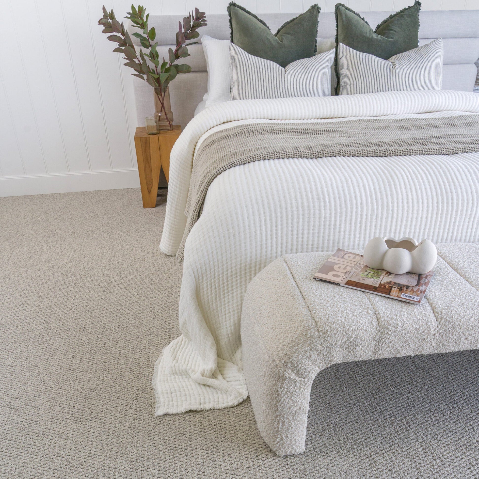 Bedroom with a bed on a textured gray carpet