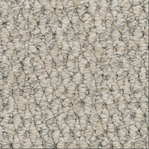 Close-up of textured beige carpet.