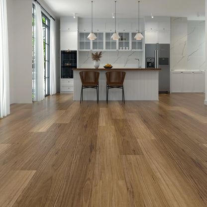 Light brown laminate flooring shown in a modern kitchen interior with white cabinetry, pendant lights, two brown chairs, and stainless steel appliances.