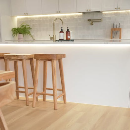Kitchen with wood look hybrid flooring.