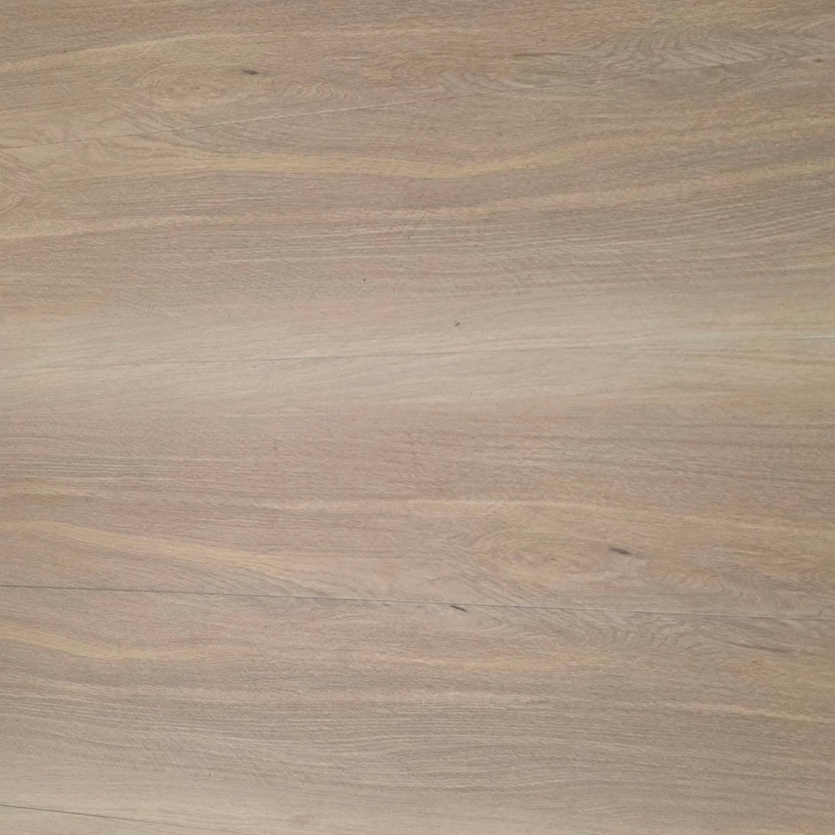 A close-up view of a light beige hybrid  wood grain surface with subtle natural texture and horizontal grain patterns.