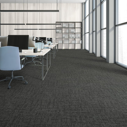 Modern office space with desks, chairs, and large windows.