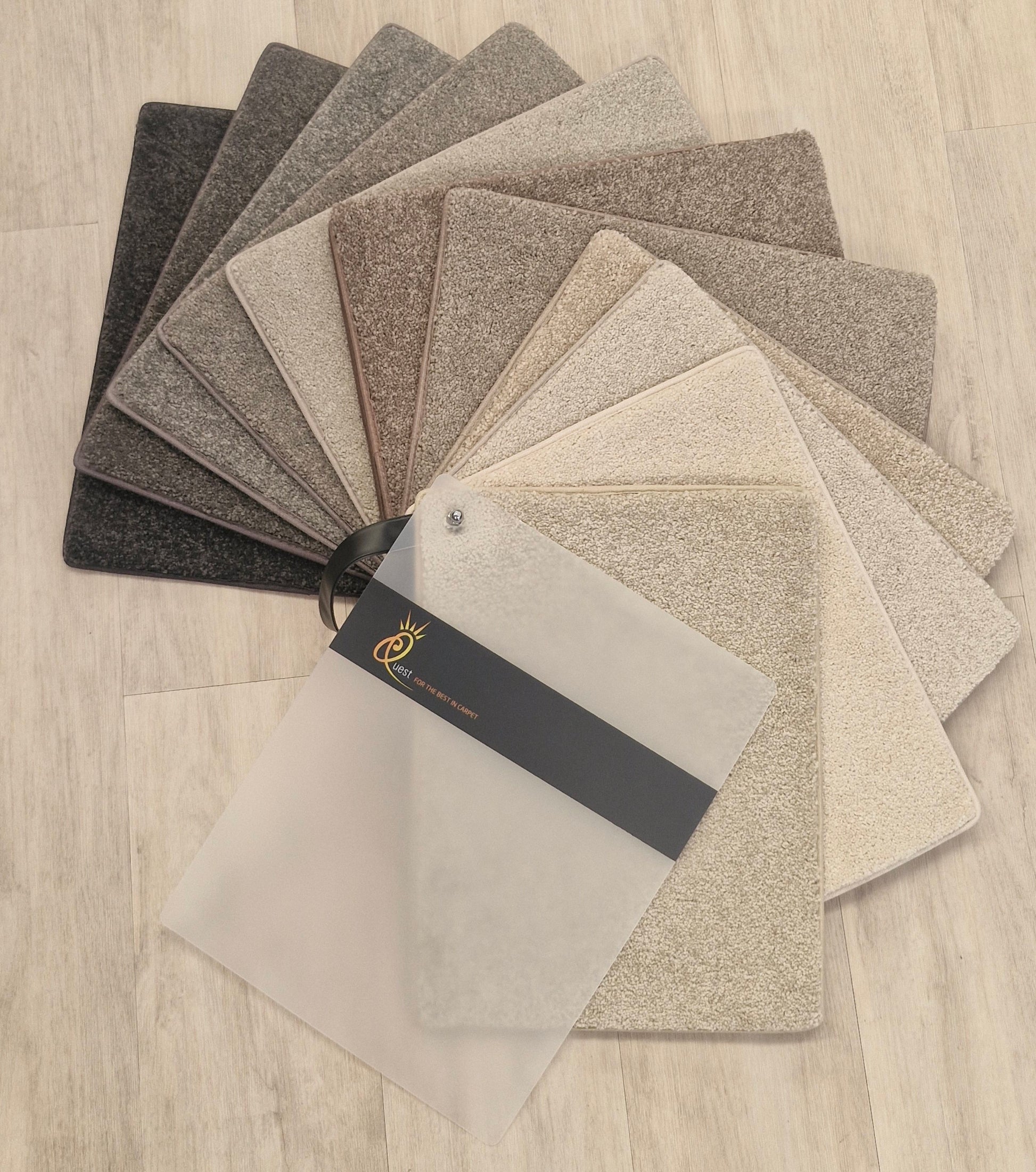 Collection of carpet samples in various shades.
