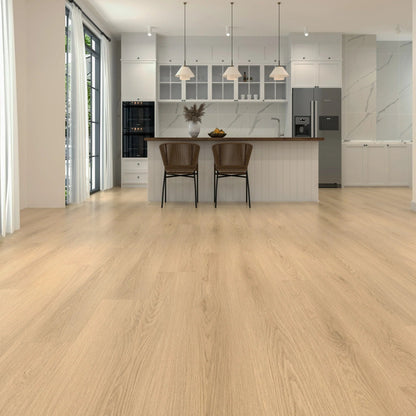 Light oak laminate flooring shown in a modern kitchen interior with white cabinetry, pendant lights, two brown bar stools, and a stainless steel refrigerator.