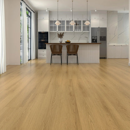 Light oak laminate flooring shown in a modern kitchen interior with white cabinetry, pendant lights, two brown bar stools, and stainless steel appliances.