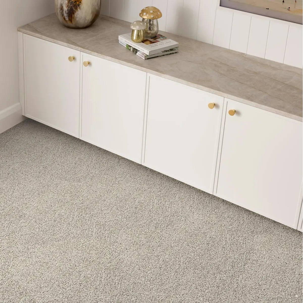 Gray carpet flooring and white cabinets.